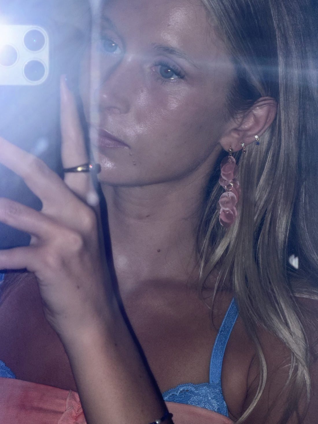 Close-up of baby pink capiz shell earring showing natural shimmer