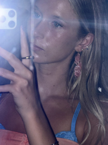 Close-up of baby pink capiz shell earring showing natural shimmer